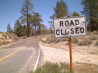 Westbound California 173 at the point where the pavement ends in San Bernardino National Forest just northwest of Lake Arrowhead. Signage displayed "Road Closed," but the road is open for use.