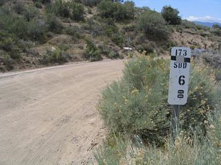 The dirt road section of California 173 is fully mileposted. This is the last milepost after California 173 changes from a dirt road east of Arrowhead Lake Road into a paved road along westbound.