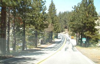 Visible through the trees to the left, SR 173 west skirts along the eastern shore of Lake Arrowhead.