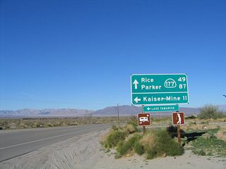 Northbound California 177 and Riverside County Route R-2 (unsigned) split here. Riverside County Route R-2 travels northwest to Lake Tamarisk and Eagle Mountain, where the highway ends. California 177 travels northeast from here toward California 62 and Granite Pass. The control points for northbound California 177 are Rice and Parker, both of which actually lie on California 62. California 177 only travels about 28 miles from end to end; California 62 east continues to Rice and Parker. Both California 177 and California 62 were built primarily to support the Colorado River Aqueduct, which follows the two state routes from near Parker (in Arizona on the Colorado River) southwest to the Chuckwalla Valley, then west toward the Coachella Valley.