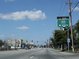 After intersection with California 178 (24th Street), northbound Buck Owens Boulevard approaches Sillect Avenue in Bakersfield. Turn left on Sillect Avenue to the on-ramp for California 99 north or turn right to see the Bakersfield Arch that spans Sillect Avenue near the Buck Owens Crystal Palace Theater and Museum.