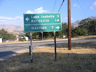 A 1969 mileage sign and a C Block are posted on eastbound Kern Canyon Road (Old California 178) at Caliente-Bodfish Road in the unincorporated community of Bodfish.