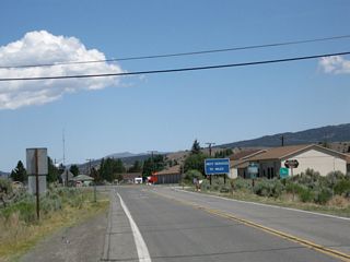 A blue information sign advises that the next services are 70 miles ahead. The next left turn connects to the Bridgeport Airport.