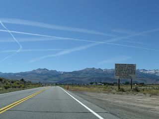 A regulatory sign advises inbound motorists to obtain a certificate of inspection for any agricultural commodities brought into the state of California.