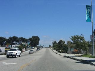 Three-lane California 183 (Merritt Street) leaves downtown Castroville and approaches the intersection with Pajaro Street and interchange with California 156.