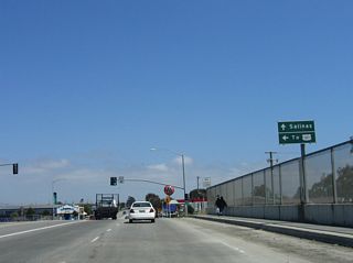 Crossing over the California 156 freeway, southbound California 183 approaches the left turn to California 156 east to Prunedale, San Juan Bautista, Hollister, and all Central Valley points via California 152/Pacheco Pass Highway. Use California 156 east to U.S. 101 north to Gilroy, San Jose, and San Francisco. Follow California 183 south to Salinas and destinations on U.S. 101 south.