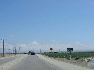 Southbound California 183 (Castroville Road) approaches Espinosa Road, which travels east to Espinosa Lake and U.S. 101 on an alignment parallel to Blackie Road and California 156.