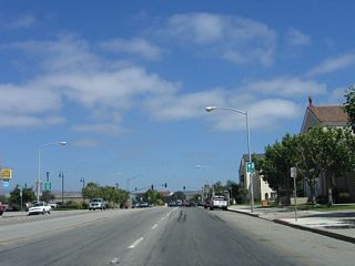 Entering downtown Salinas, southbound California 183 (Market Street) leaves the industrial areas and finds more residential areas. On the left is the Amtrak station. The traffic signal in the distance is with Salinas Street, followed by Monterey Street. Salinas Street and Main Street form a one-way couplet for U.S. 101 Business. At this interchange, California 183 will turn left (north) onto Monterey Street, then end at U.S. 101 (El Camino Real) Exit 329. Meanwhile, Market Street will continue east to U.S. 101 Exit 328 (this is the better route to U.S. 101 south).