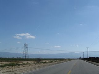 Shortly thereafter, a single-circuit Pacific Gas and Electric 500V power transmission lines crosses over Wheeler Ridge Road. This line, which is part of Path 26, carries electricity between the Midway substation in Buttonwillow to the Vincent substation off California 14 and the Angeles Forest Highway near Soledad Pass. The northern portion of this line was built by Pacific Gas and Electric and has 500kV towers based on the standard PG&E design. Upon crossing the Tehachapi Mountains to the southeast of here, the lines change into Southern California Edison 500kV towers. Since this line travels through some very remote terrain, the next place to see this line to the southeast is on California 138, and by that point it is Southern California Edison.