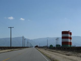 As Wheeler Ridge Road continues to gain elevation, the Grapevine and Tejon Ranch come into view. At Wheeler Ridge, Interstate 5 continues south through the Tehachapi Mountains en route to Los Angeles. Most of the terrain here at the southern end of the Central Valley is fertile, irrigated, and agricultural.
