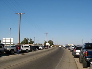 More cars line California 186 as it finds its way north away from the port of entry and border crossing with Mexico. As can be seen by the clothes worn by the pedestrian, it was a cold day in the desert this January afternoon.