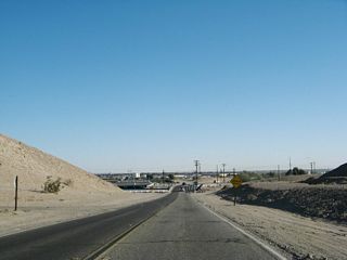 After ascending to a hill, California 186 descends toward the All American Canal crossing, which was built in 1938 at the same time the canal was built. To the west of California 186 is Pilot Knob Mesa, which sits 742 feet and separates the Colorado River valley from the Imperial Valley.