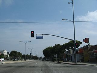 Venice Boulevard passes by Venice High School and meets Beethoven Street at this traffic signal. A business district lines both sides of Venice Boulevard.