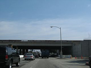 California 187 (Venice Boulevard) approaches and passes under the Interstate 405 mainline.
