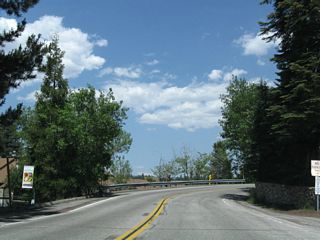 California 189 continues east from Blue Jay to Lake Arrowhead Village ("Old World Charm, New World Excitement").