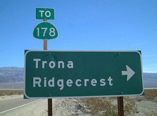Eastbound California 190 approaches its intersection with Panamint Valley Road in Panamint Springs. Note the trailblazer sign to California 178, which begins at a point southwest of Trona.