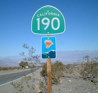 A California 190 east reassurance shield (with scenic route marker) is posted after the Wildrose Road/Emigrant Canyon cutoff.
