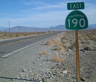 Further ahead, a California 190 east reassurance shield is posted in Death Valley.