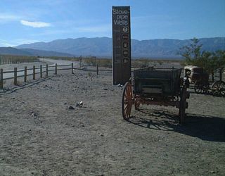 Westbound California 190 approaches Stovepipe Wells, the first services since Furnace Creek. Unlike many other national parks in the United States, the primary route remains signed as a state route throughout Death Valley National Park. Compare this to the numerical routes entering Yellowstone National Park or Yosemite National Park, which are not signed.