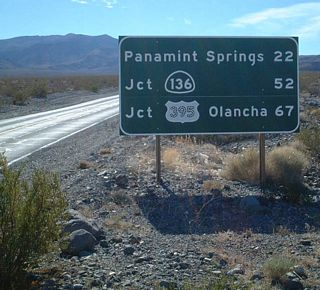 A mileage sign along westbound California 190 is posted at the Wildrose Road and Emigrant Canyon Cutoff intersection.