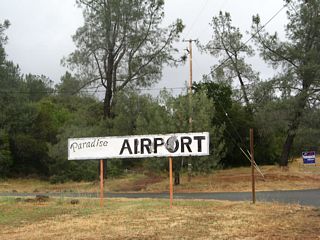 A large sign advises of the turnoff to Paradise Airport.