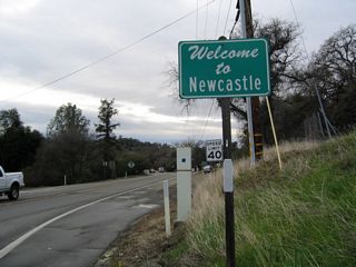 California 193 west enters the unincorporated community of Newcastle.