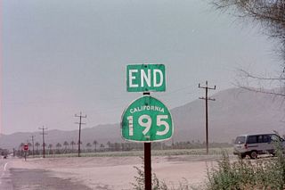 Westbound California 195 approaches Former California 86 (Harrison Street) south of Thermal and Coachella. This end shield was in place in June 1999; subsequent visits in 2009 show the end shield is no longer in place. Almost all California 195 signage is gone between the California 86 expressway and Former California 86 (Harrison Street).