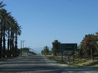 This mileage sign along former California 195 (Pierce Street) used to provide the distance to Mecca (eight miles), Desert Center (51 miles), and Blythe (99 miles). It is not clear if these mileages assumed motorists would take California 86 north to Interstate 10 west to Desert Center and Blythe or follow Box Canyon Road (former U.S. 60-70).