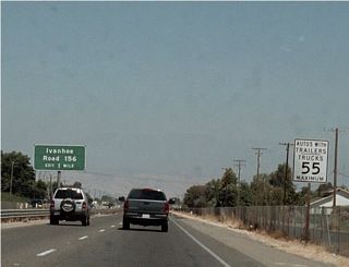 Eastbound California 198 approaches Exit 110, Road 156 north to California 216 en route to Ivanhoe and Woodlake. The freeway segment continues east for a few more miles before ending.