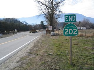 Westbound California 202 ends just south of Bear Valley Road at the entrance to the California Correctional Institute.