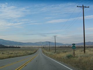 The final reassurance shield for SR 202 west stands southwest of Cummings Valley Road.