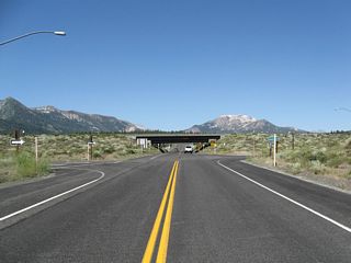 Postmile 8.67 for SR 203 precedes the diamond interchange joining Substation Road with U.S. 395.