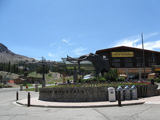 A wooly mammoth (elephant) stands guard in front of the Mammoth Mountain gondola terminal. Tickets for the gondola and shuttle bus to Reds Meadow is located within the building behind the wooly mammoth. During winter, the road typically is unplowed beyond this point and thus is closed in winter west of here. Access to Devils Postpile and Reds Meadow is limited during winter due to snow closures.