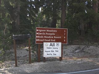 This mileage sign along Minaret Road provides the distance to Agnew Meadows (three miles), Devils Postpile (seven miles), Reds Meadow (eight miles), and Roads End (eight miles). The last eight miles are all under U.S. Forest Service maintenance and are not part of California 203. The road is only open in Summer and requires a fee to be paid for entry, typically through the shuttle bus fare.