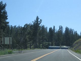 Continuing nearly due west, Mount Reba Road ends at the parking lot for the Bear Valley Mountain Resort. From this point, a driveway leads north down a series of switchbacks to the resort lodge, main parking lot, and ski run.