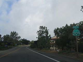 Removed by June 2009, this was the first shield for northbound California 209 in Fort Rosecrans Military Reservation. Some of the facilities in this military reservation include communications equipment and a large national cemetery. Due to security requirements, the military imposes a nightly curfew on the segment of California 209 that passes through the military reservation: unauthorized traffic is not allowed after dusk beyond a military checkpoint just south of Mills Street.