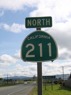 The first reassurance shield for California 211 appears along Main Street north between Van Ness Avenue and Market Street.