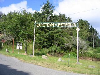 An arch for the communities of Capetown and Petrolia stands at the corner of Ocean Avenue and Wildcat Avenue south in Ferndale. Mattole Road traverses Bear River Ridge southwest to Capetown, then straddles the Pacific Coast from south of Cape Mendocino. The road turns inland to Petrolia across McNutt Gulch. Mattole Road links with Wilder Ridge Road at the town of Honeydew.