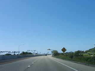 The divided highway and freeway end right after the ramp from California 217 (Clarence Ward Memorial Boulevard) to Exit 1, Sandspit Road and Moffett Place.