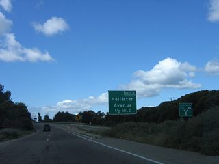 The first exit along westbound California 217 (Clarence Ward Memorial Boulevard) is Exit 2, Hollister Avenue (old U.S. 101). A second sign in the background shows the split on the on-ramp from Fairview Avenue to either U.S. 101 north or California 217 west.