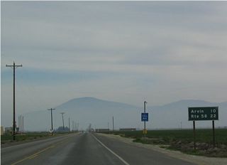 This mileage sign along eastbound California 223 is posted after passing the Union Avenue (California 99 Business) intersection. Arvin is ten miles east of here, and the eastern terminus of California 223 (at California 58) is 22 miles east of here.