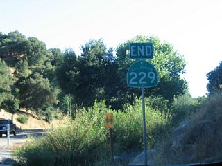 An end SR 229 shield assembly appears at SR 58 in Calf Canyon. Through traffic from southbound SR 229 to westbound SR 58 do not need to stop here.