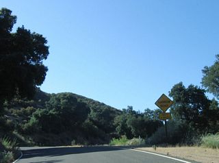 Northbound California 229 sees a one-and-a-half lane configuration: There is no center yellow painted line, and the white lines are painted at the edges of the pavement. A "Narrow Road Next 6 Miles" sign is posted shortly after California 229 north splits away from California 58 northeast of Santa Margarita in rural San Luis Obispo County.