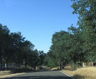 SR 229 passes Granite Ridge to the east ahead of post mile 3.00.