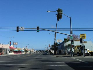 Northbound California 233 (Robertson Boulevard) meets 5th Street at this traffic signal. Fifth Street southeast changes into southbound Road 16, which connects to California 152. Downtown Chowchilla is just ahead on California 233 north.