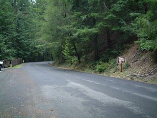 The highway was recently paved when this picture was taken.  At the right side of the roadway (along northbound) is a small sign welcoming visitors to another of California's state parks.