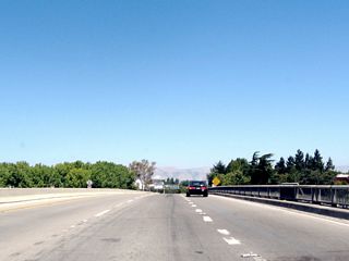 1950s-era bridge rail lines eastbound California 237 as the freeway passes over U.S. 101 (Bayshore Freeway).