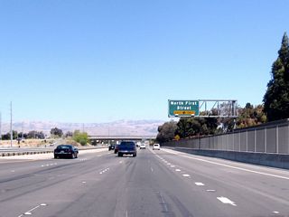 The new right lane becomes exit only for North First Street, which travels south toward downtown San Jose on an alignment generally parallel to the Guadalupe River.