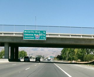 This interchange sequence sign provides the distance to the next three exits along California 237 east: Exit 9A, McCarthy Boulevard and Cypress Street; Exit 9B, Interstate 880 (Nimitz Freeway) north to Oakland; and Exit 9C, Interstate 880 (Nimitz Freeway) south to San Jose.