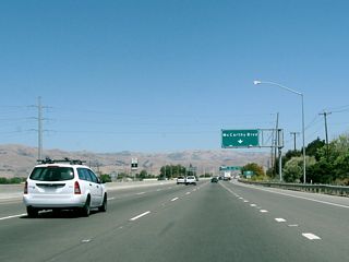 The right lane of California 237 east becomes exit only for Exit 9A, McCarthy Boulevard and Cypress Street. California 237 leaves San Jose and enters the city of Milpitas. Situated on Interstate 680, Interstate 880, and California 237, Milpitas is known as the "Crossroads of Silicon Valley" with its freeway access. Home to 62,698 people as of the 2000 Census, Milpitas was incorporated as a city on January 26, 1954, as it was threatened with potential annexation by the city of San Jose.